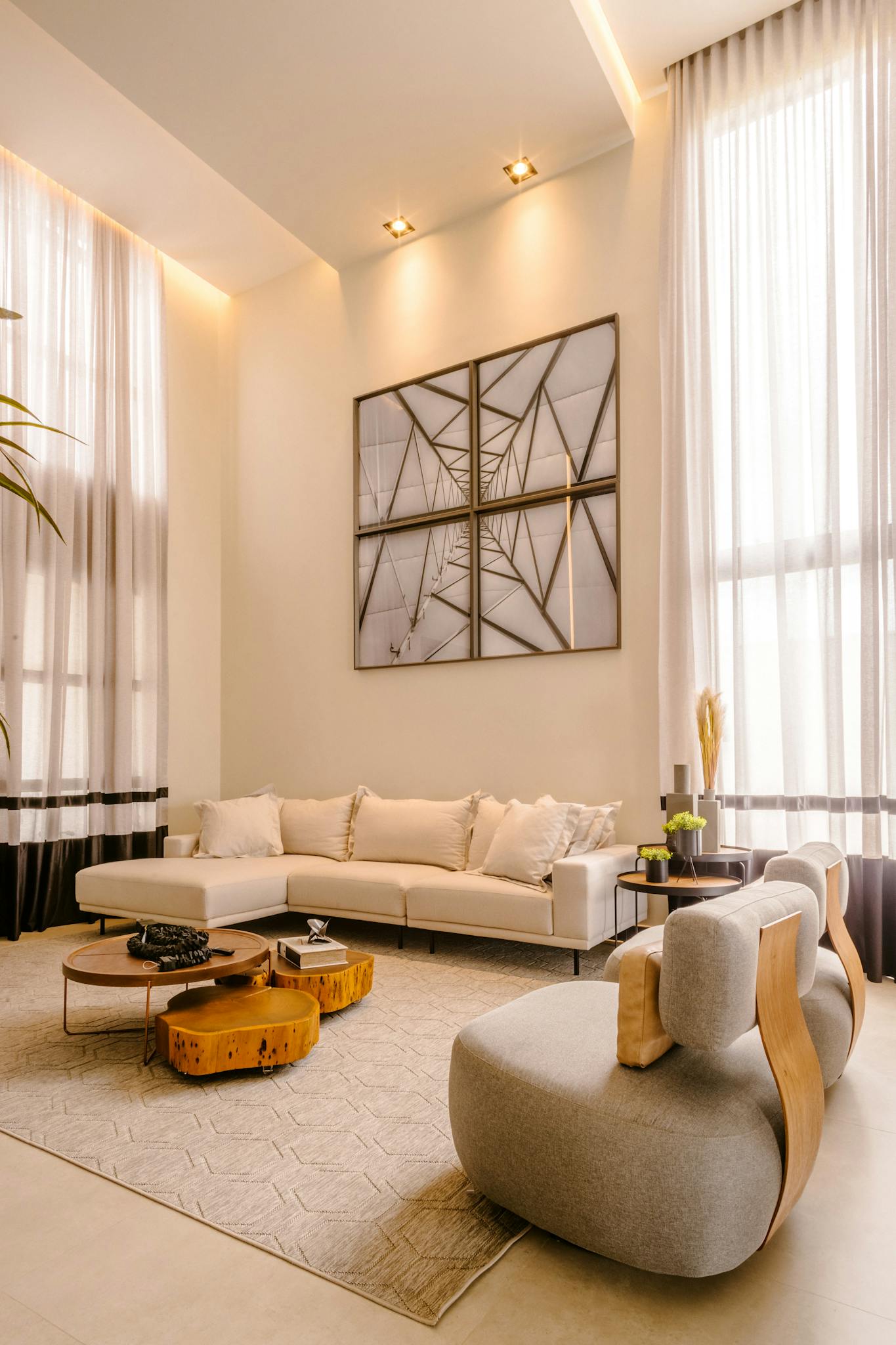 Stylish modern living room with high ceilings, minimalist decor, and neutral palette.